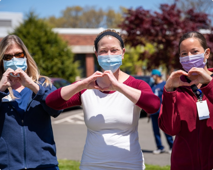 Women showing love sign